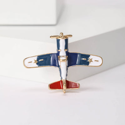 A front-facing propeller airplane in red white and blue shown on a white background