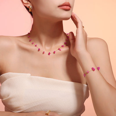 Model wearing pink stone station necklace and matching bracelet