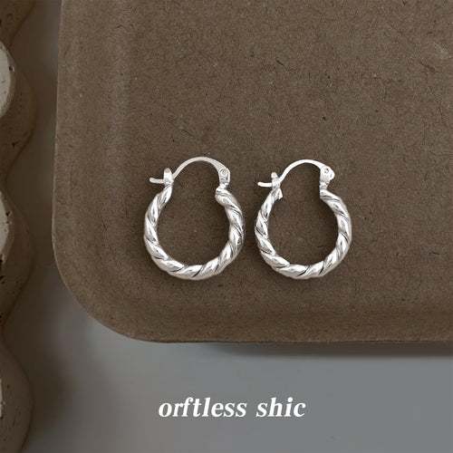 Silver twisted rope hoops pair on brown ceramic tray