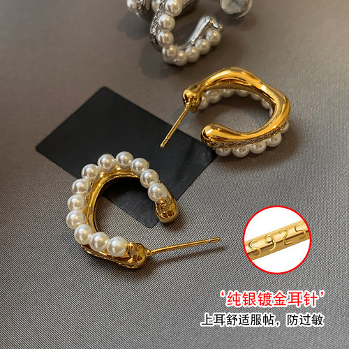 Styled ear view of gold tone double row pearl hoop stud earrings fashion jewelry
