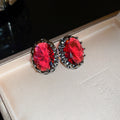 Dark Silver Tone Oval Stud Earrings With Faceted Red Centers view 6