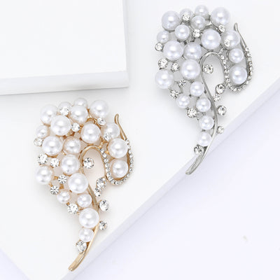 Front view of curved leaf shaped spray set with pearls and clear crystals