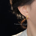 Gold Tone Lotus Flower Bud Curved Stem Stud Earrings view 2