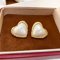 Pearl-Like Heart Stud Earrings with Gold Trim with Polished Metal Details view 6