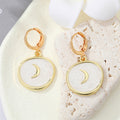 Gold Tone Crescent Disc and Yin Yang Heart Huggie Earrings view 6
