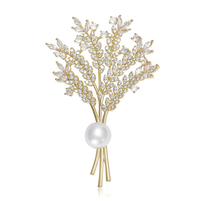 Front view of a gold-tone sheaf of fine wheat stems tied with two white pearls