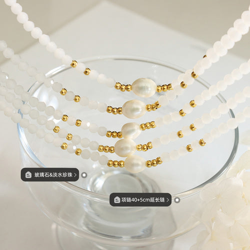 White glass and pearl strands close-up with material and size labels