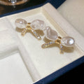 Pearl Bow And Floral Stud Earrings With Polished Metal Tone Details view 6