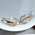 Two-Tone Twisted Teardrop Huggie Earrings with Clear Stone Details view 4