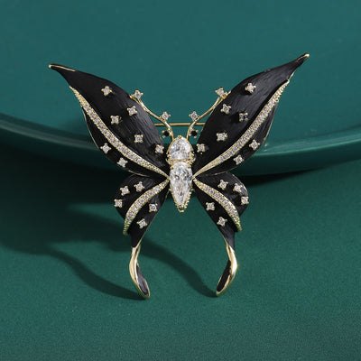 Front view of the black enamel butterfly brooch with crystal details on a white background