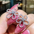 Silver Tone Four Petal Floral Stud Earrings with Clear Stones view 2