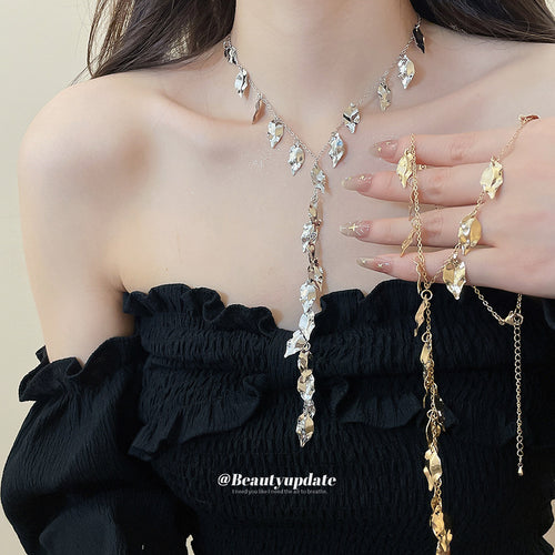 A slender Y silhouette made from cascading polished leaf charms shown in a styled view.