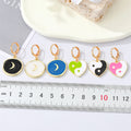 Gold Tone Crescent Disc and Yin Yang Heart Huggie Earrings view 2