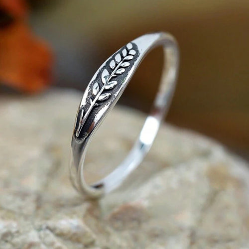 Side angle of antique silver leaf motif band on stone
