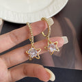 Gold Tone Clear Star and Stone Huggie Hoop Earrings view 3