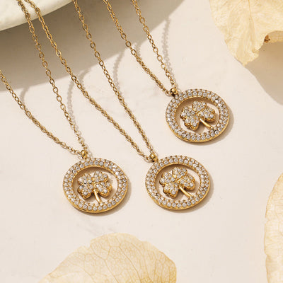 Gold clover pavé circle pendant necklace flat lay with shells