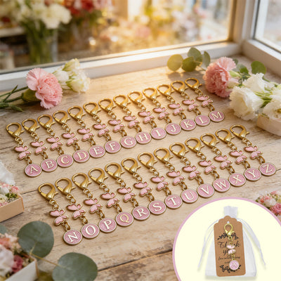 Full A–Z pink enamel letter keychains with butterfly charms and favor bag inset