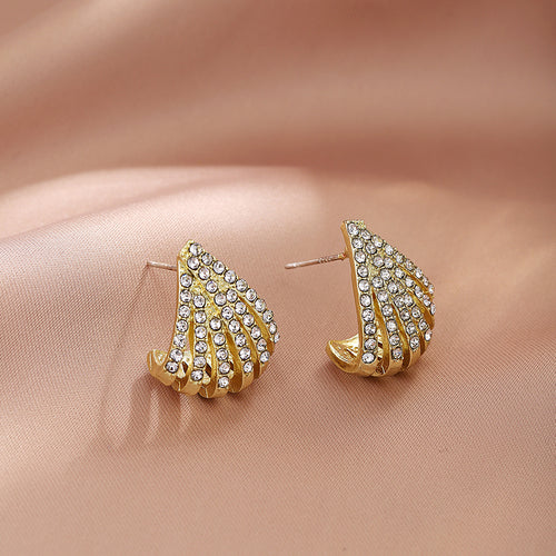 Gold fan geometric rhinestone studs on soft pink satin fabric