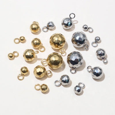 Grouped front view of polished metal ball charms in ten size and finish options