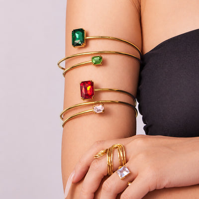 Arm stacked with gold double open cuffs red green clear stones