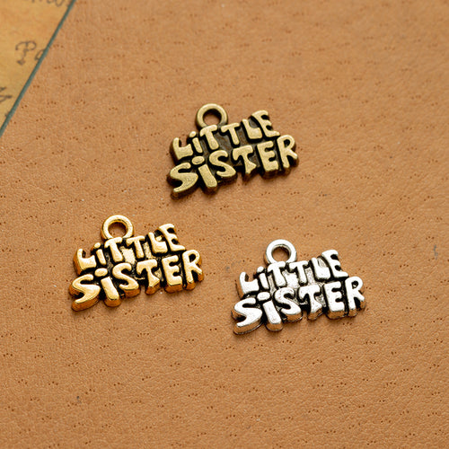 Main product image of the little sister word charm showing stacked Little Sister lettering with a small top loop