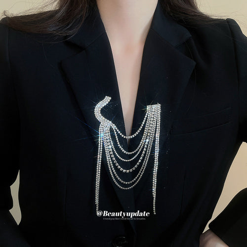 Silver multi layer rhinestone tassel brooch pinned on black blazer lapel