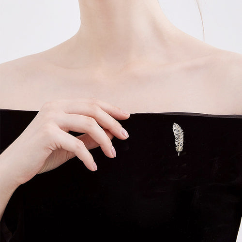 Gold crystal feather brooch close-up barbs detail