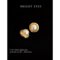 Gold Tone Round Openwork Pearl Stud Earrings With Textured Frame view 1