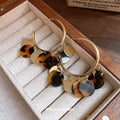 Gold Tone Hoop Earrings with Brown Tortoiseshell Disc Fringe view 2