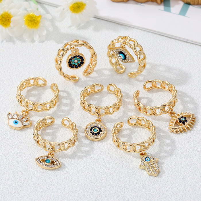 Gold Tone Curb Chain Crystal Evil Eye and Hamsa Charm Rings