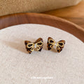 Gold Tone Bow Stud Earrings With Black Enamel Accents view 4