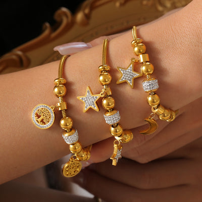 Wrist stacking three gold star moon and tree of life bead bracelets
