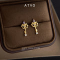 Gold Tone Iris Key Shape Purple And Clear Stone Stud Earrings view 4
