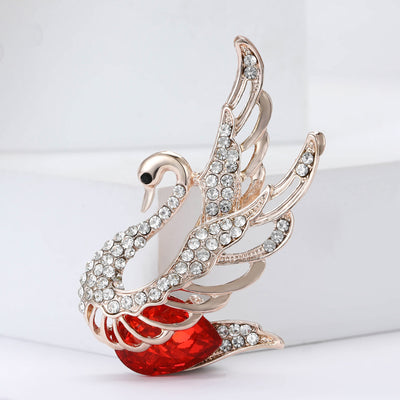 Front view of the crystal swan brooch showing a silver-tone crystal swan with layered wings and red enamel body