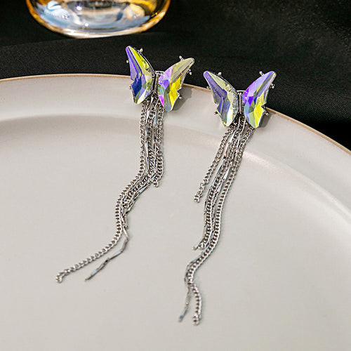 Pair of aurora butterfly silver chain tassel earrings on white plate
