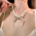 White Pearl Look Bow Fringe Collar Necklace with Metal Tone Details view 1