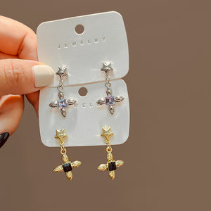 Gold-Tone Alloy Star Drop Earrings with a Black Crystal Cross