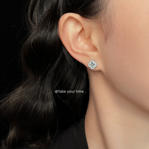 Light blue clover stud worn on ear side profile