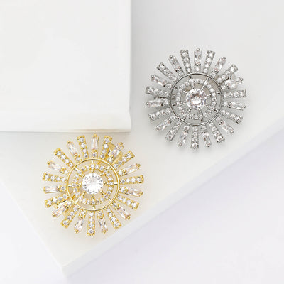 Front view of a round center stone surrounded by two rings of silver-tone crystal rays