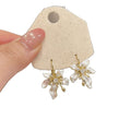 White Floral Drop Earrings with Gold Tone Petal Accents view 5