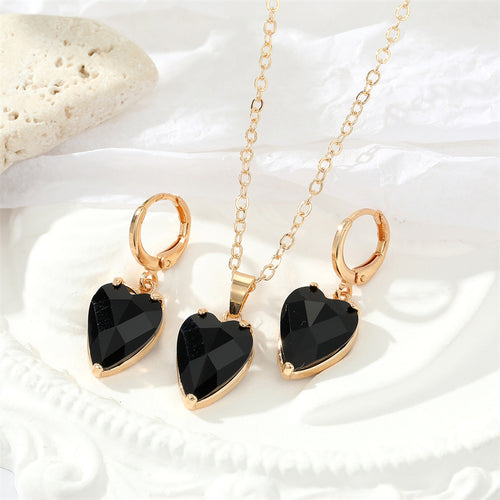 Black faceted heart pendant necklace with matching gold lever-back hoop earrings