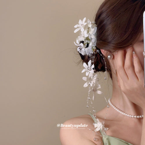 white flower lace duckbill hair clip with pearl-like long tassels shown worn in a styled second view