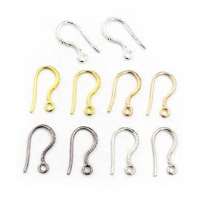 Overview of fishhook earring wires with a small ball and loop in five finishes on a light background