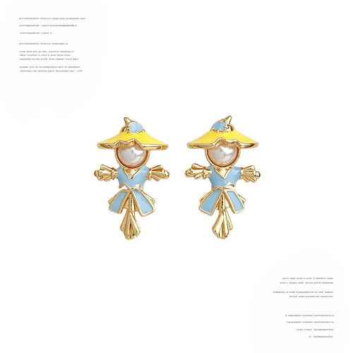 Gold-tone blue-outfit white-pearl scarecrow studs in the first product display.