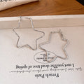 Large Open Star Hoop Earrings in Gold and Silver Tones view 6