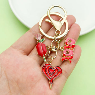 Image 1 showing a person holding two different colored key chains.