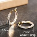 Gold Tone Crystal Twisted Oval Hoop Earrings Polished Metal Earrings view 4