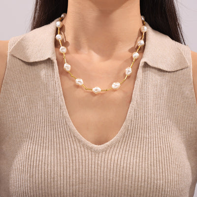 Model wearing gold irregular pearl station necklace