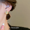 Gold Tone Brushed Oval Stud Earrings With Clear Crystal Centers view 4