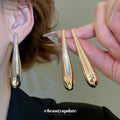 Sculptural Long Teardrop Stud Earrings in Silver and Gold Tones view 1